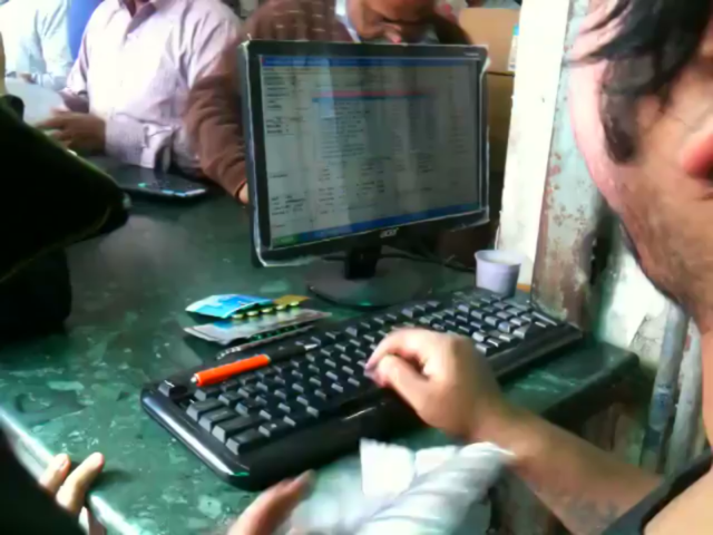 This receptionist at a busy pharmacy in India.